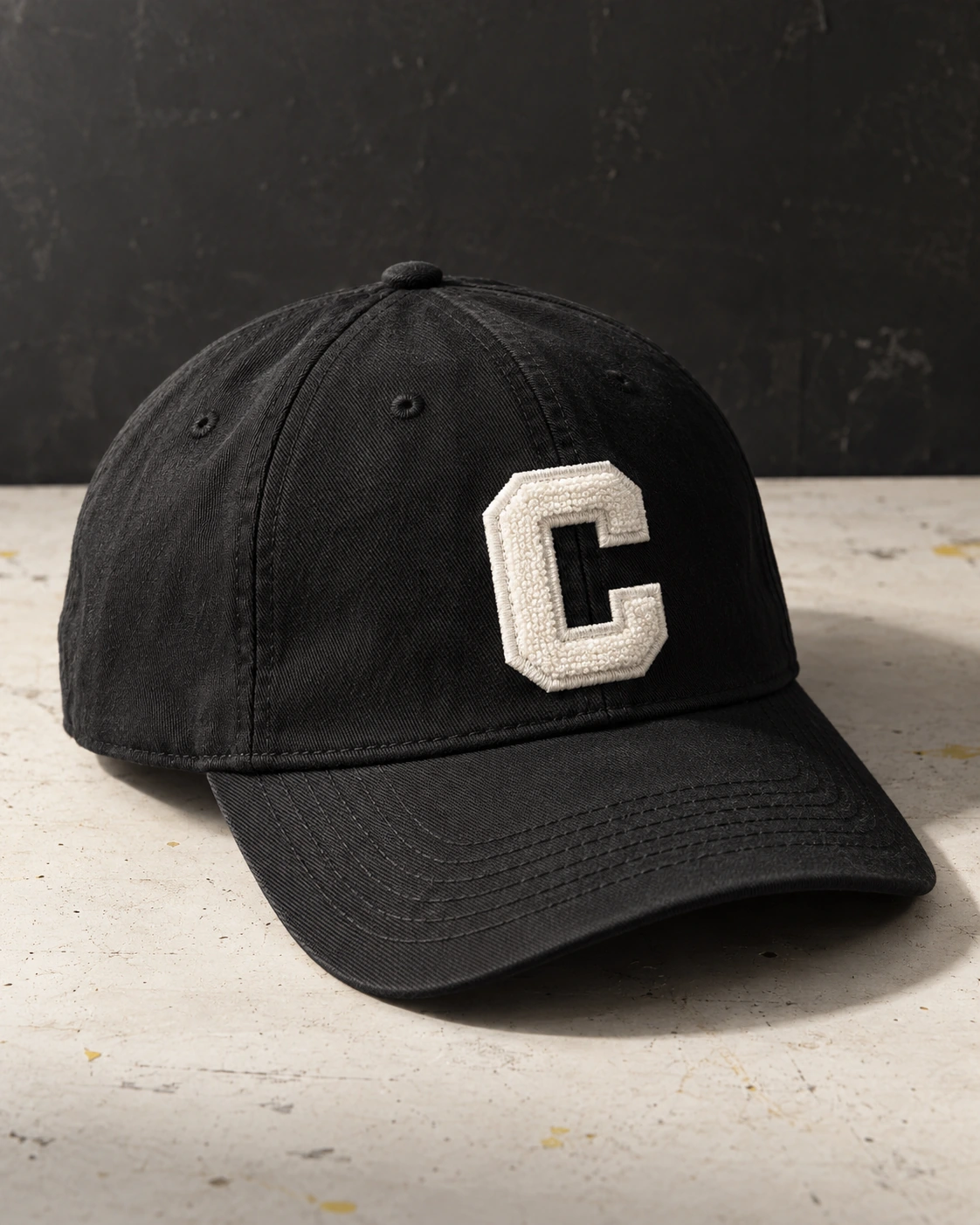 Black cap with a varsity letter C.